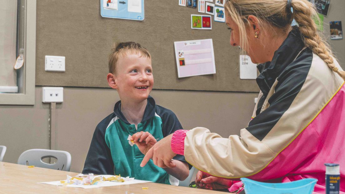 Student and teacher share engaged, supportive classroom moment